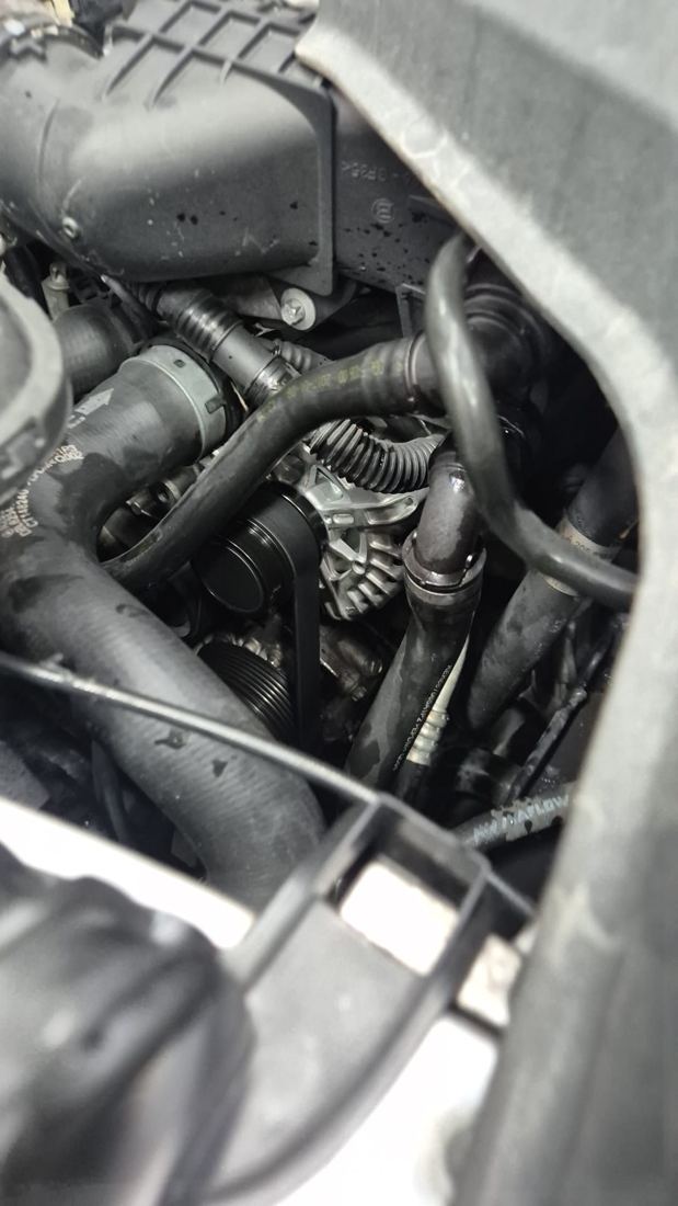 A replacement alternator fitted in the engine bay, driven by the belt